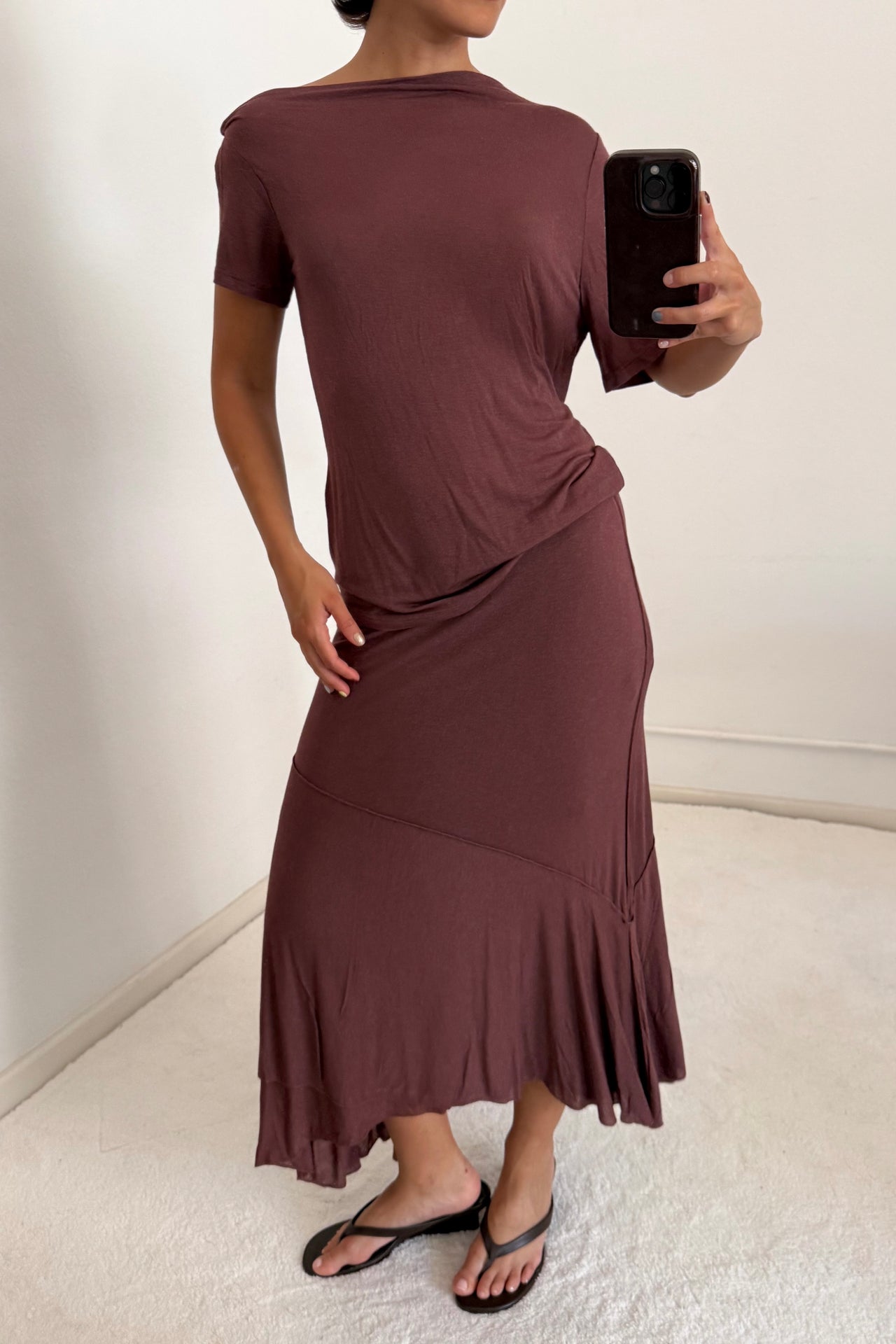 Side profile of the Alina Top, illustrating the soft drape and lightweight texture of the burgundy fabric.