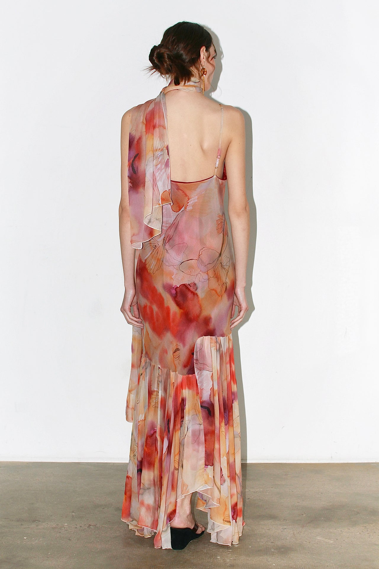 Front view of the Alma Dress in soft pink and orange abstract floral print, featuring thin adjustable straps and a flounced hem.
