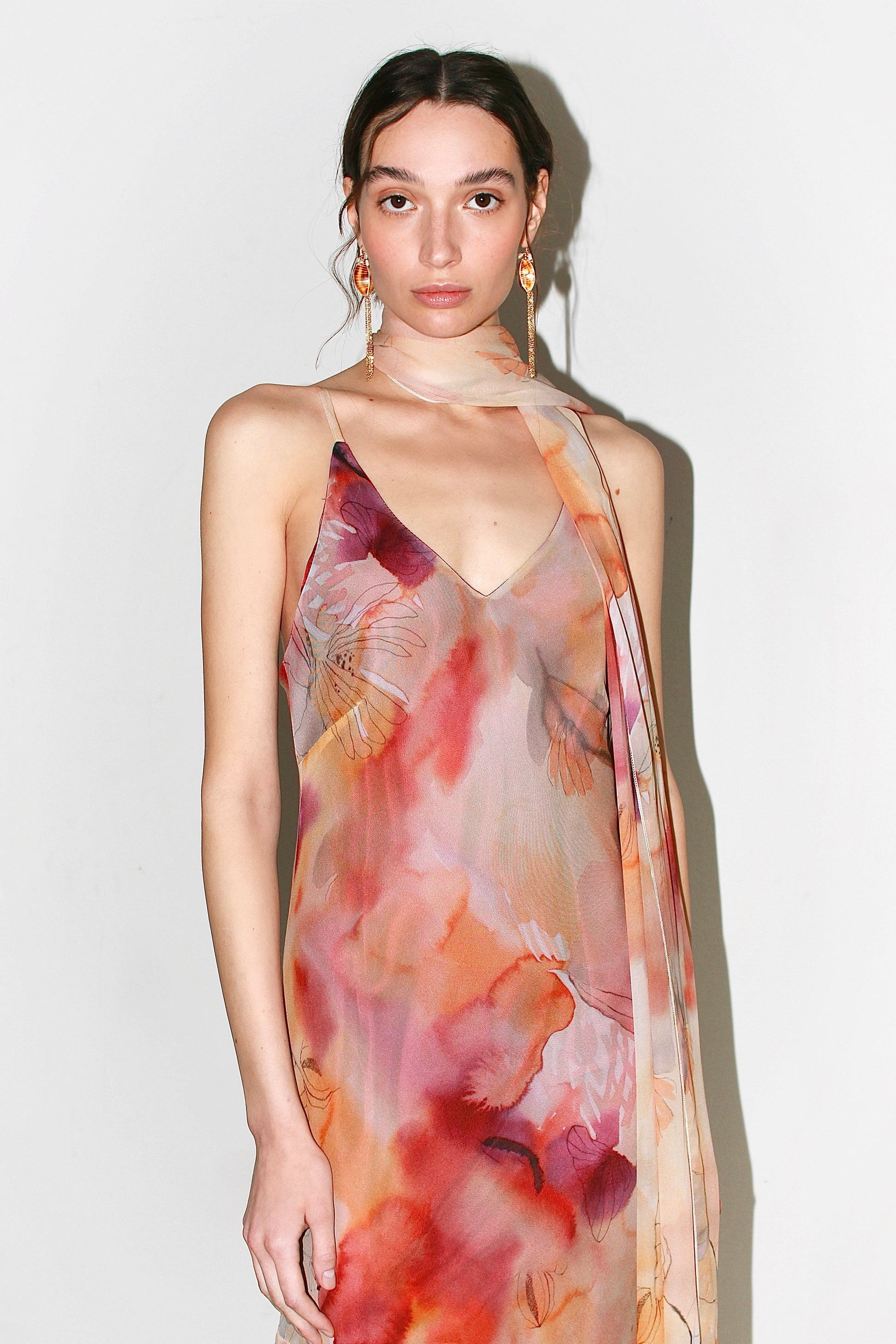 Side profile of the Alma Dress displaying the cascading flounced hemline and fluid drape.