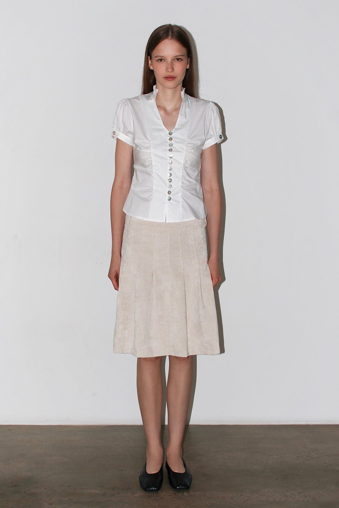 Front view of the Paloma White Shirt – short-sleeved white satin shirt with a fitted waist and button-up design.