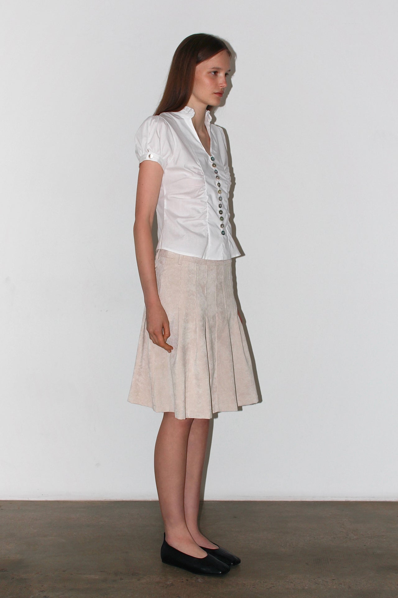 Front view of the Paloma White Shirt – short-sleeved white satin shirt with a fitted waist and button-up design.