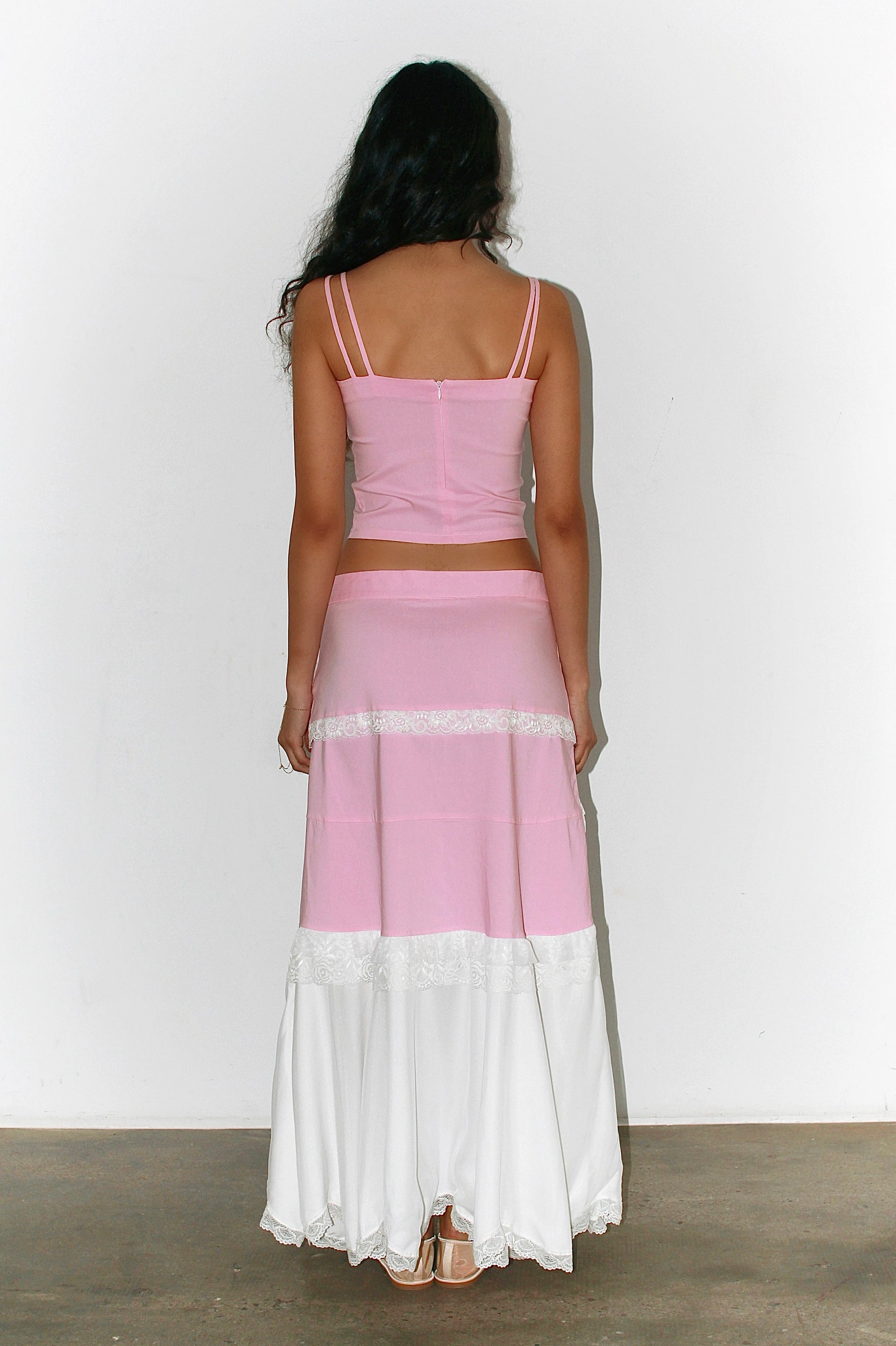 Back view of the pink and white outfit – flowing skirt and fitted top, feminine and lightweight look.