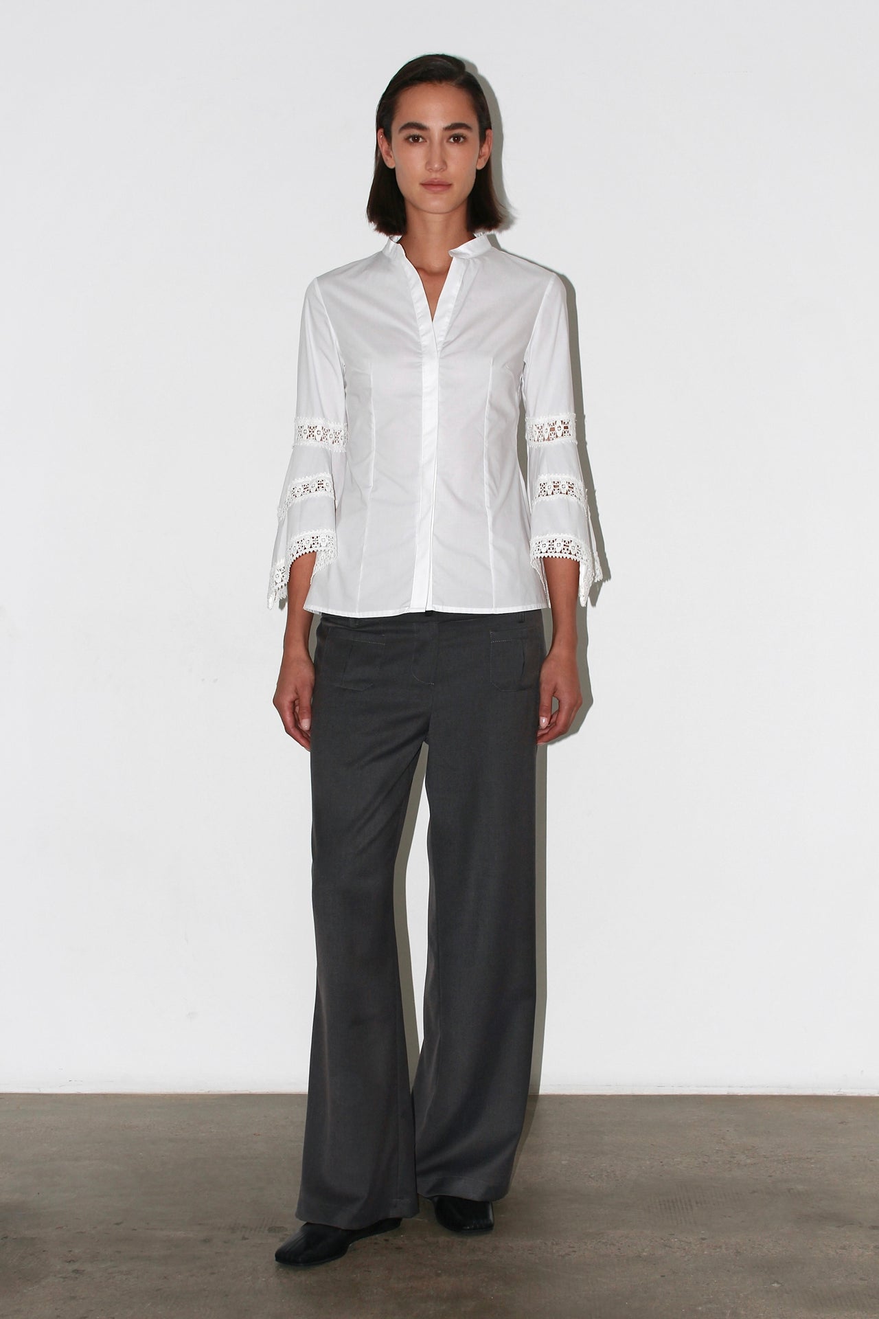 Front view of the Valentina Pants – high-waisted dark grey trousers with a straight leg and minimalist cut.