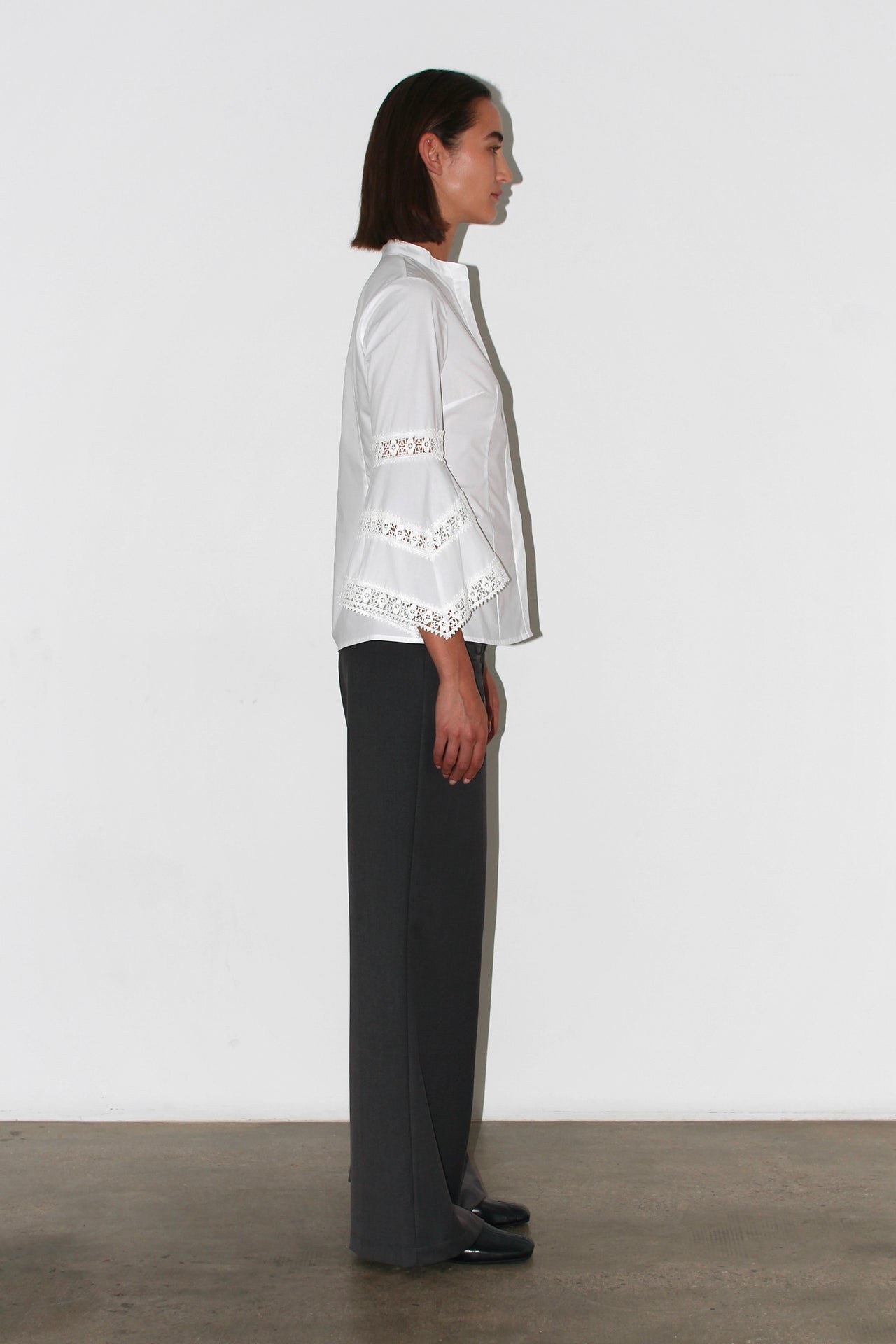 Front view of the Valentina Pants – high-waisted dark grey trousers with a straight leg and minimalist cut.