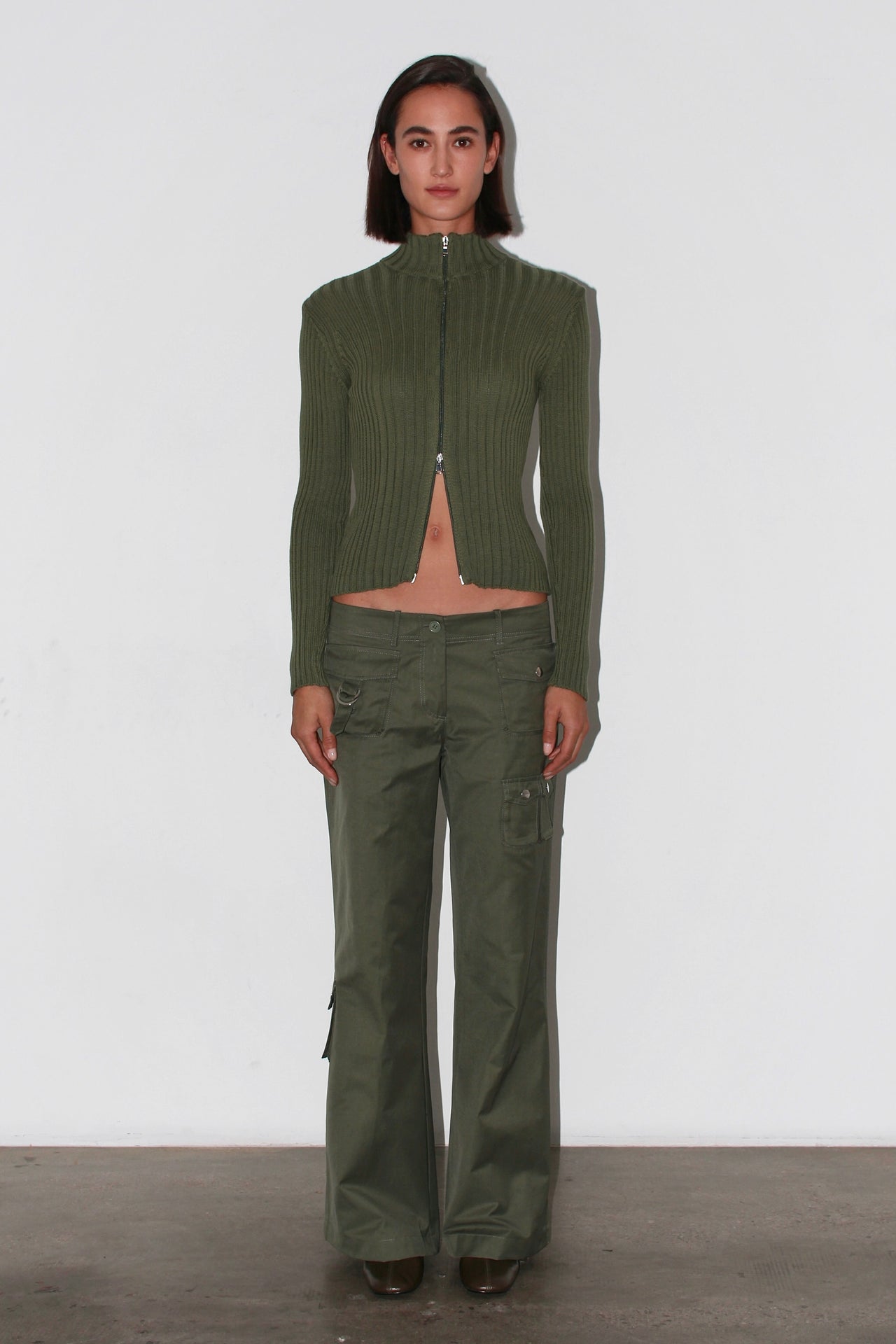 Front view of the Barca Knit Top – fitted khaki green ribbed knit with long sleeves and high neckline.