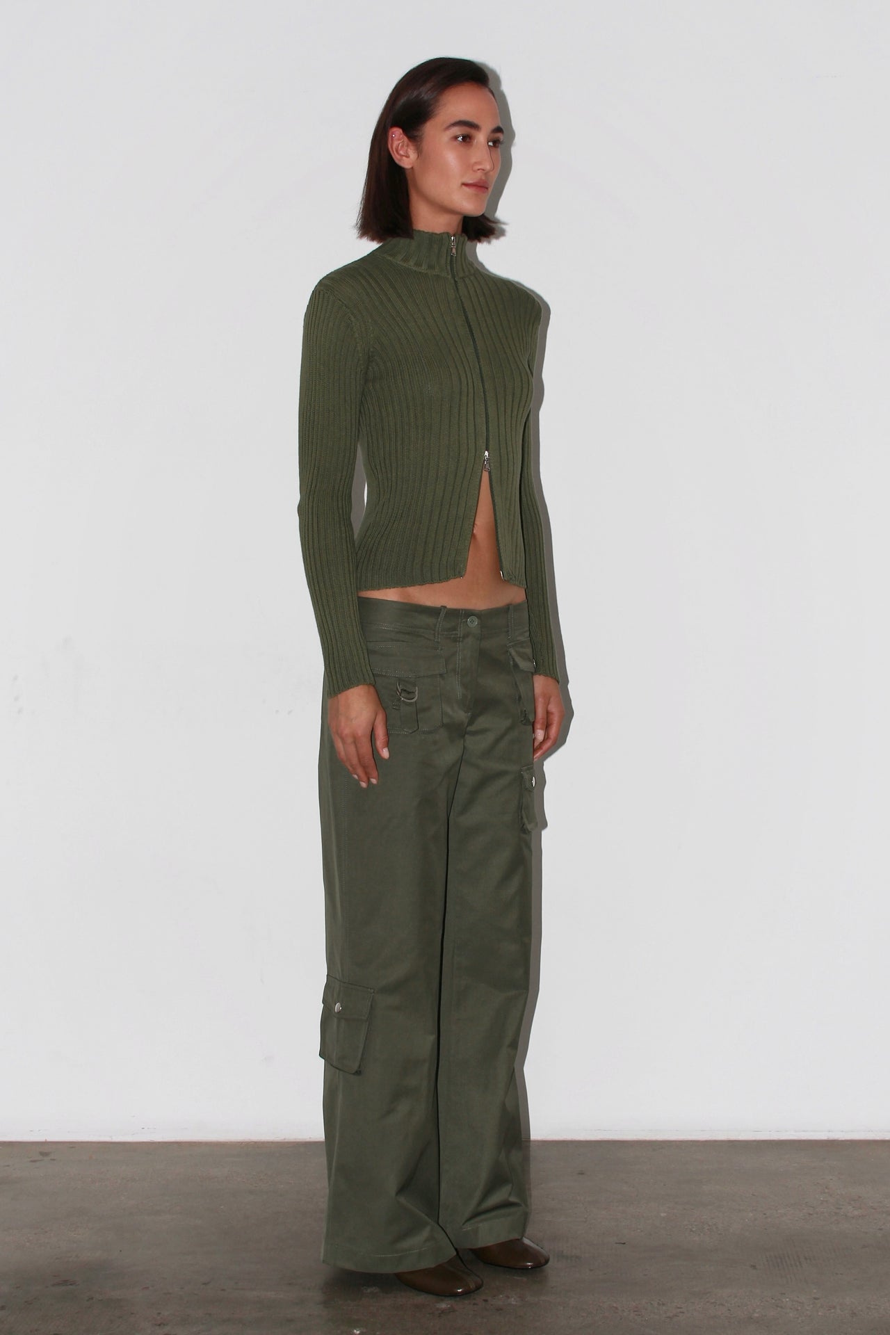 Front view of the Barca Knit Top – fitted khaki green ribbed knit with long sleeves and high neckline.