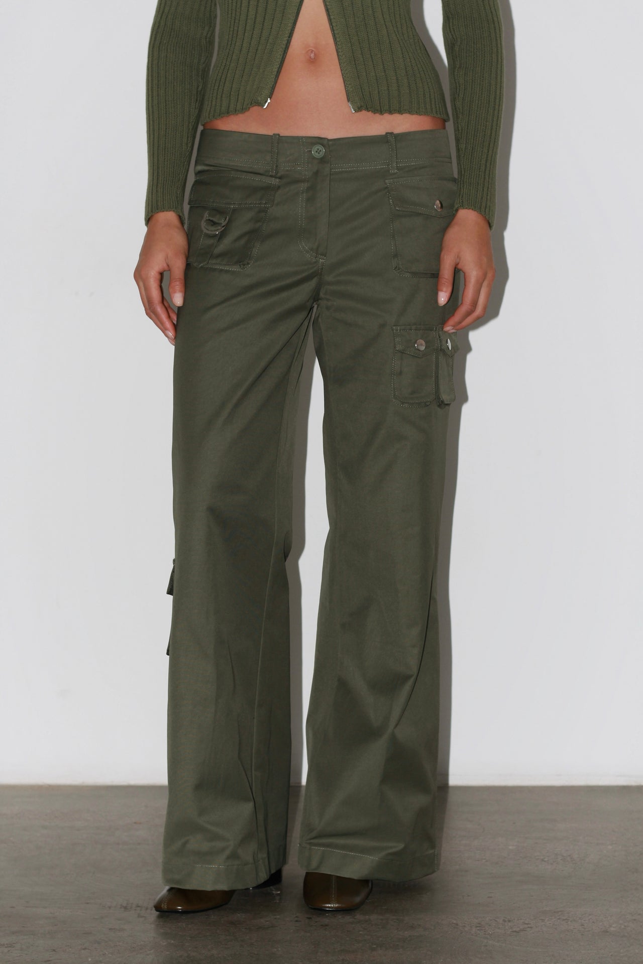 Front view of the Marina Green Pants – high-waisted khaki green trousers with straight leg and front seams.