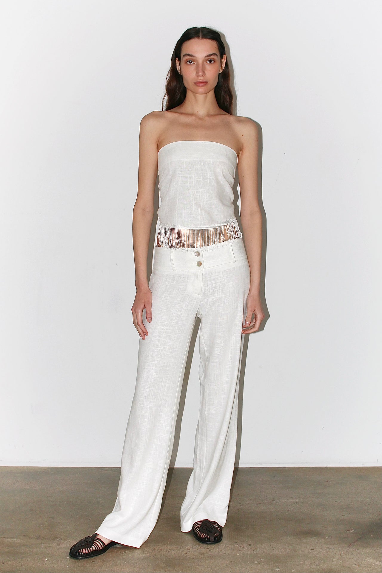 Front view of the Nour Set – white two-piece outfit featuring a bandeau top and high-waisted straight pants.