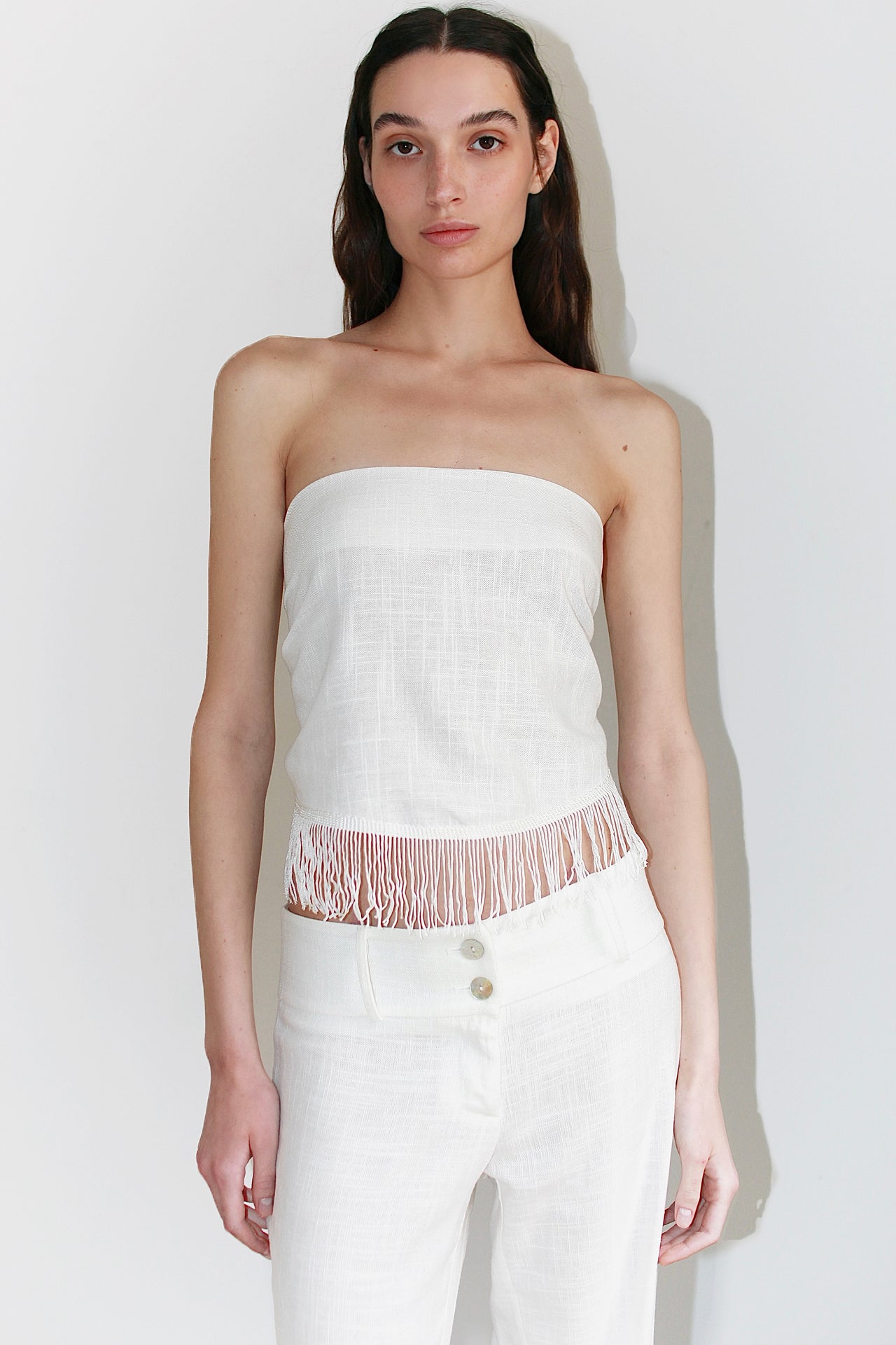 Front view of the Nour Set – white two-piece outfit featuring a bandeau top and high-waisted straight pants.