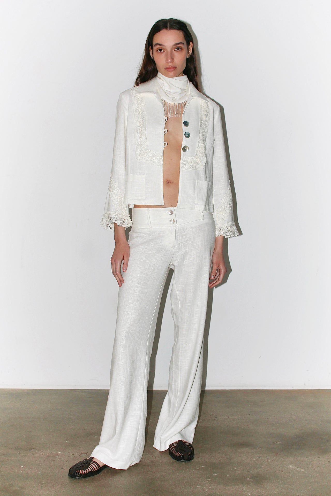 Front view of the Carlota Jacket in white – structured blazer with a straight cut and minimalist design, paired with matching pants.
