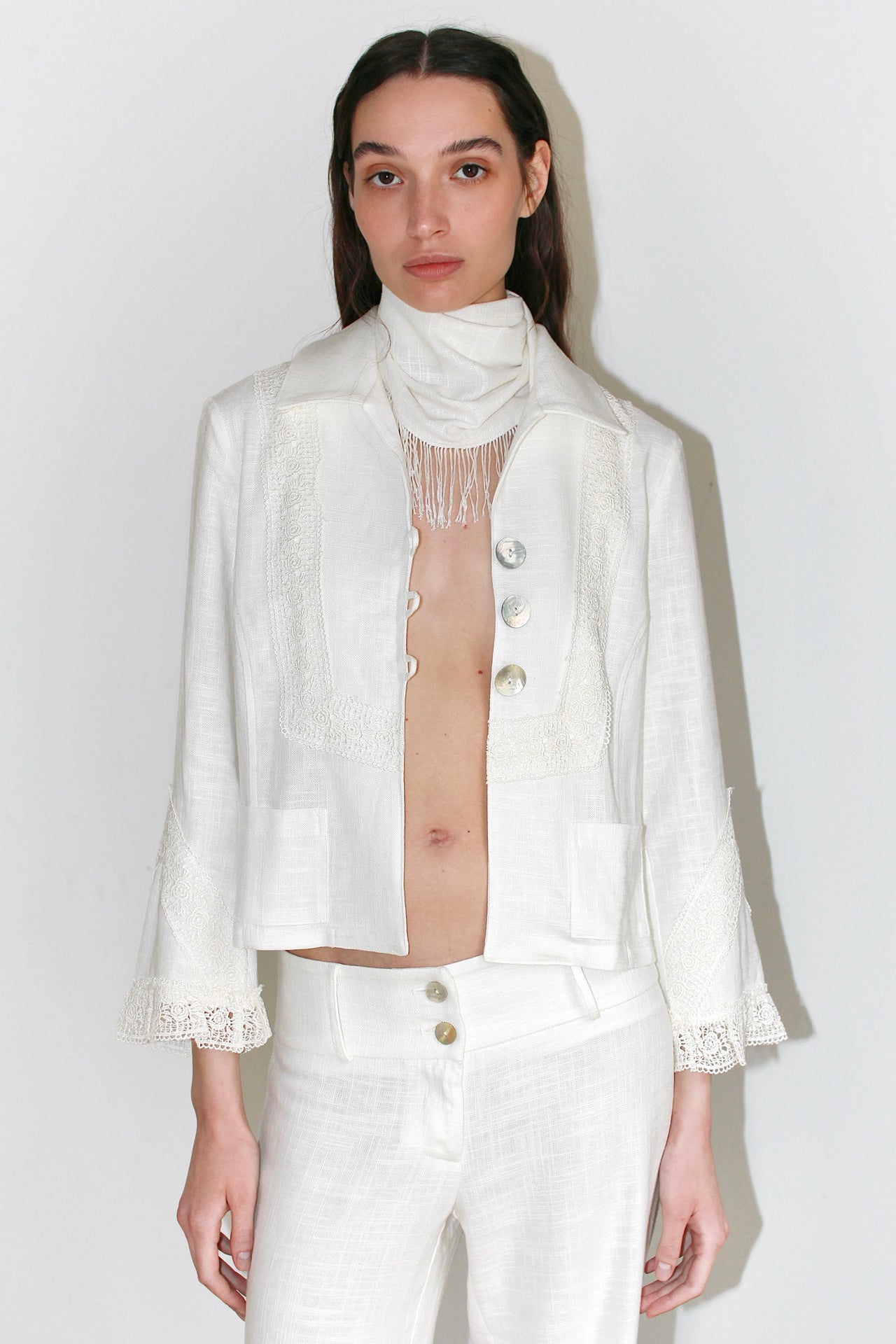Front view of the Carlota Jacket in white – structured blazer with a straight cut and minimalist design, paired with matching pants.
