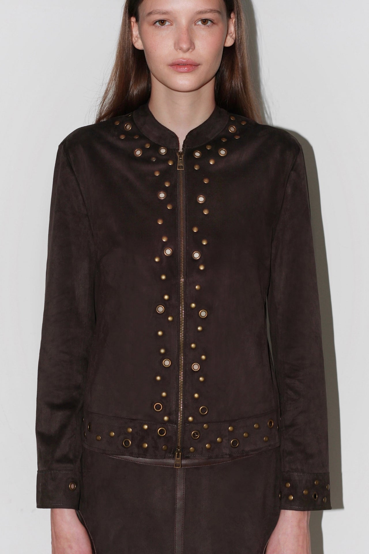 Front view of the Bella Brown Jacket – structured dark brown jacket with gold buttons and high collar.
