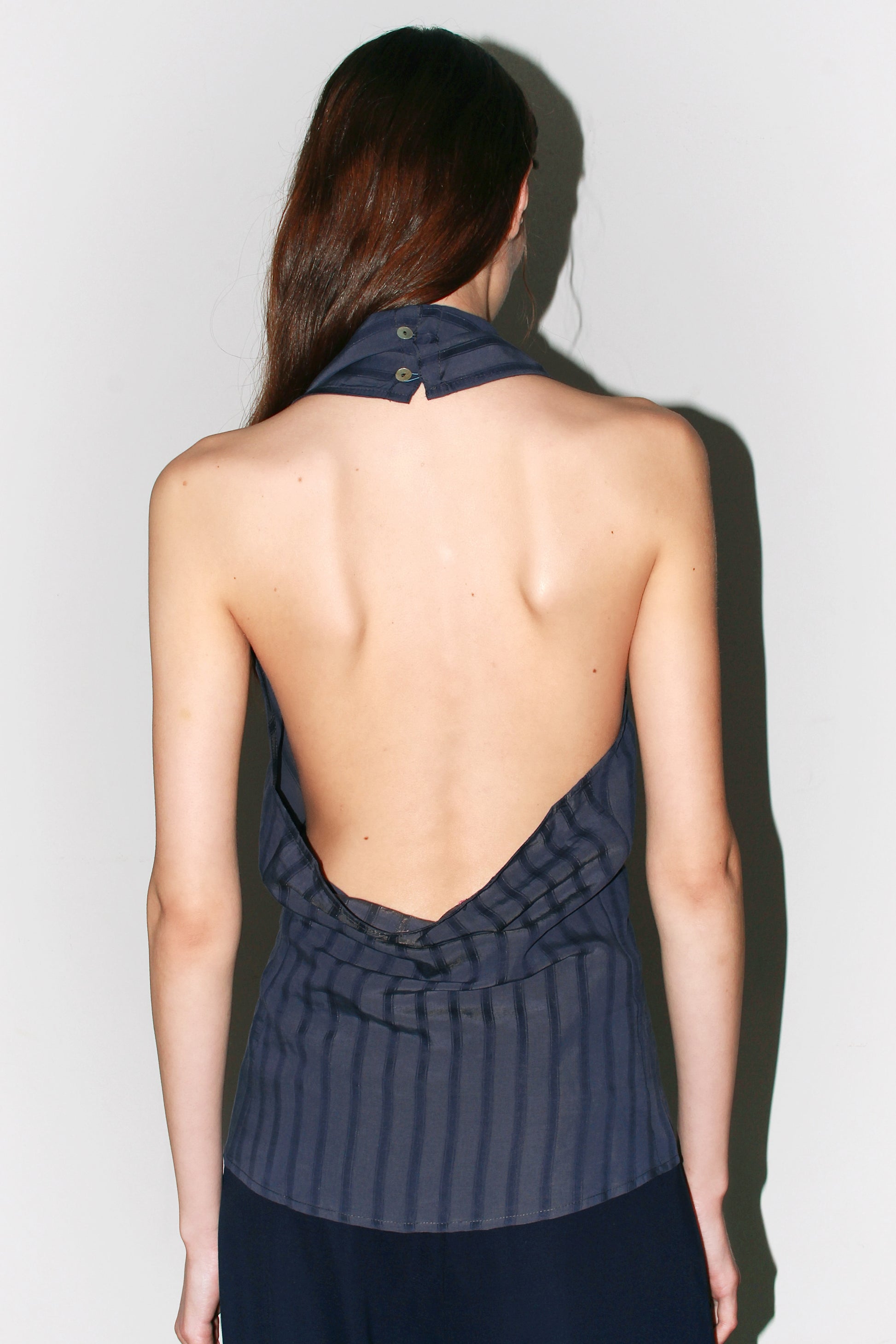 Back view of the Belen Top – open back design with low-cut finish, sleek and feminine look.