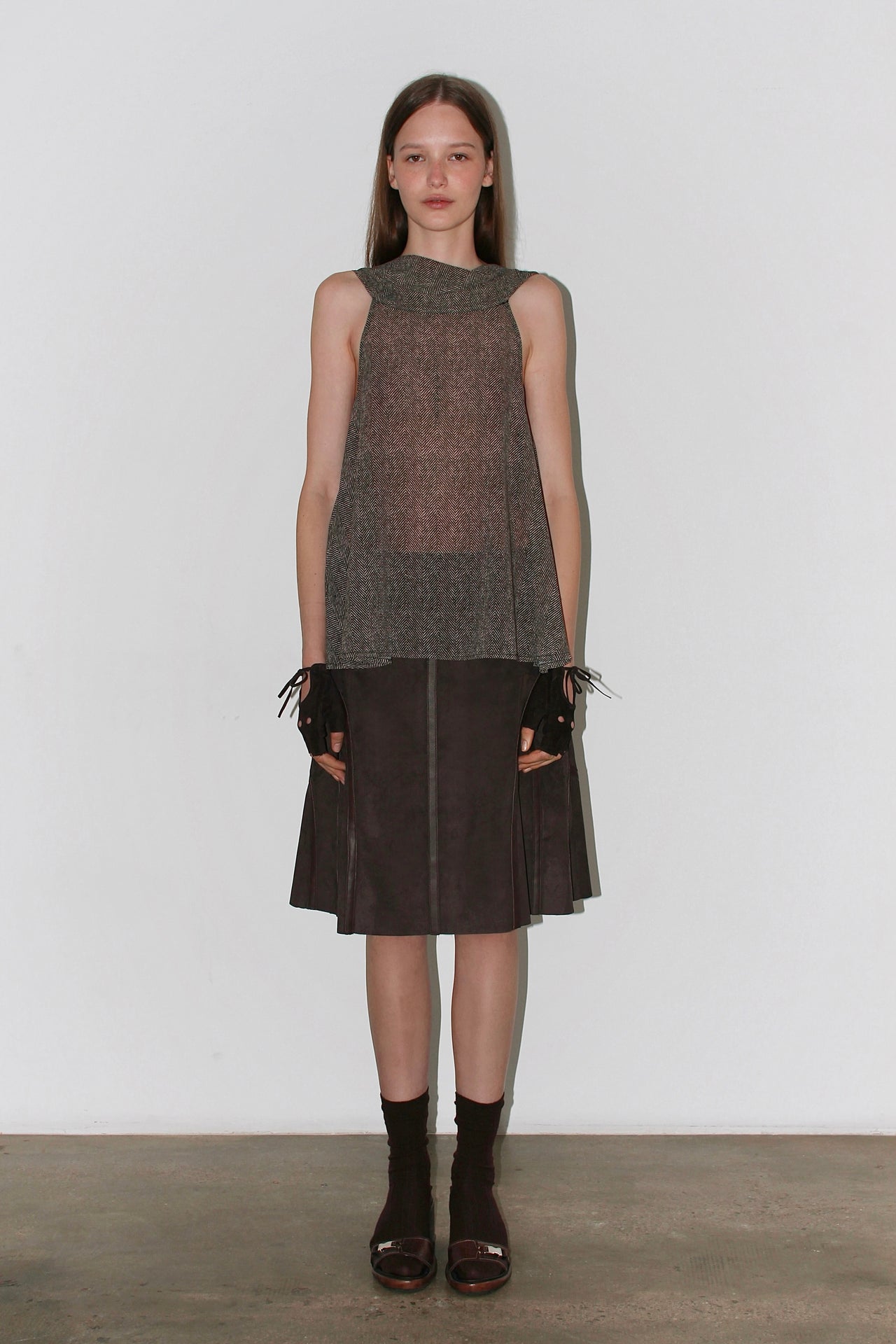 Front view of the Barbara Top – sleeveless brown halter top with high neckline and elegant drape.