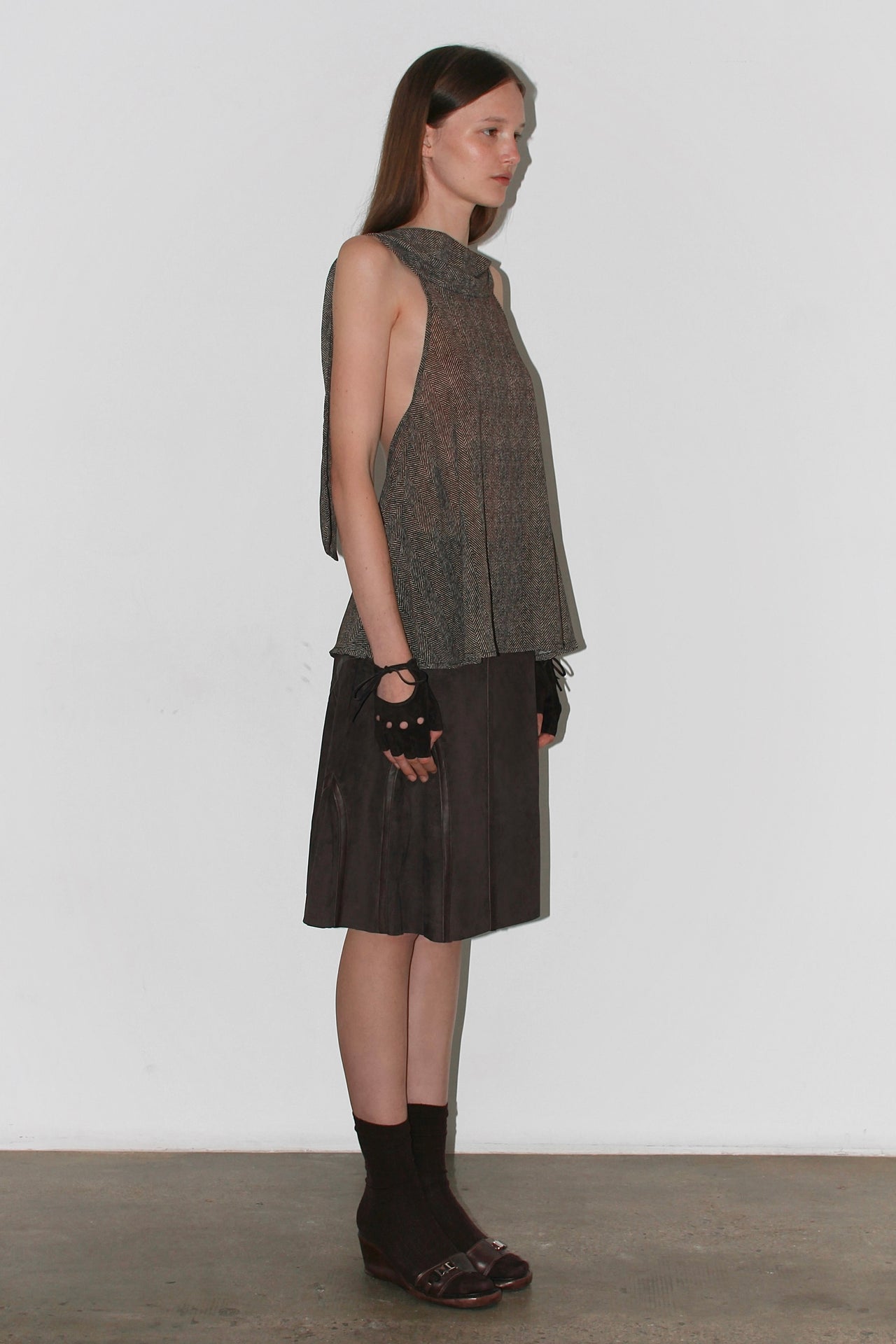 Front view of the Barbara Top – sleeveless brown halter top with high neckline and elegant drape.