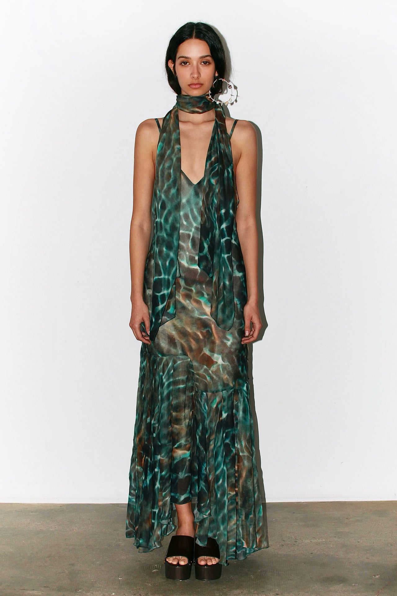 Front view of the Alma Dress in blue and green water-inspired print, featuring thin adjustable straps and a flowing silhouette.
