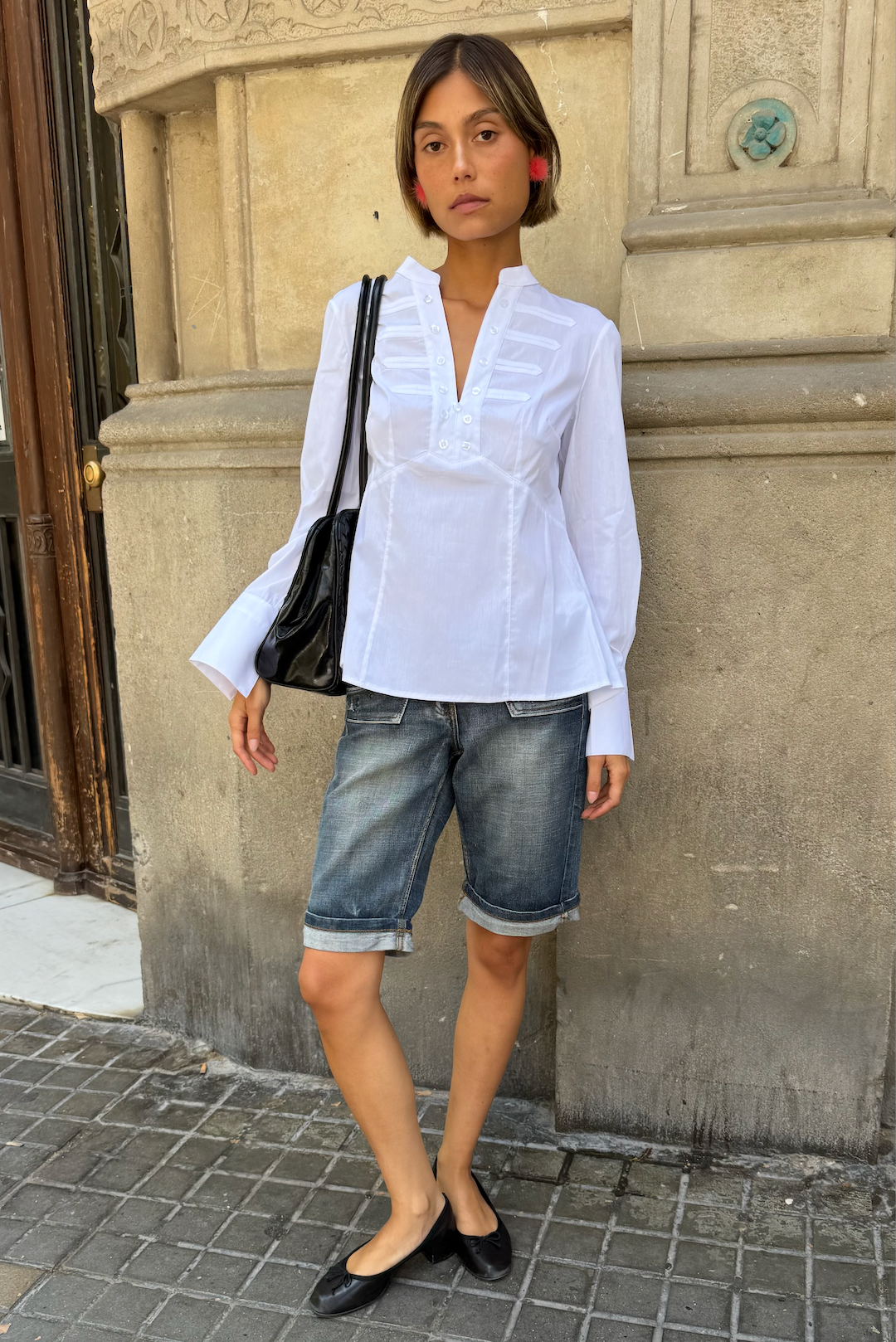 Consuelo white blouse laid flat, showing collar and buttoned bib