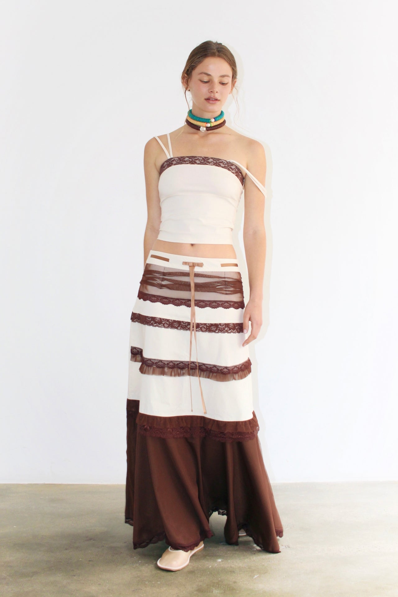 Front view of the Clara Brown Skirt – long skirt with brown and white panels, structured yet flowing silhouette.
