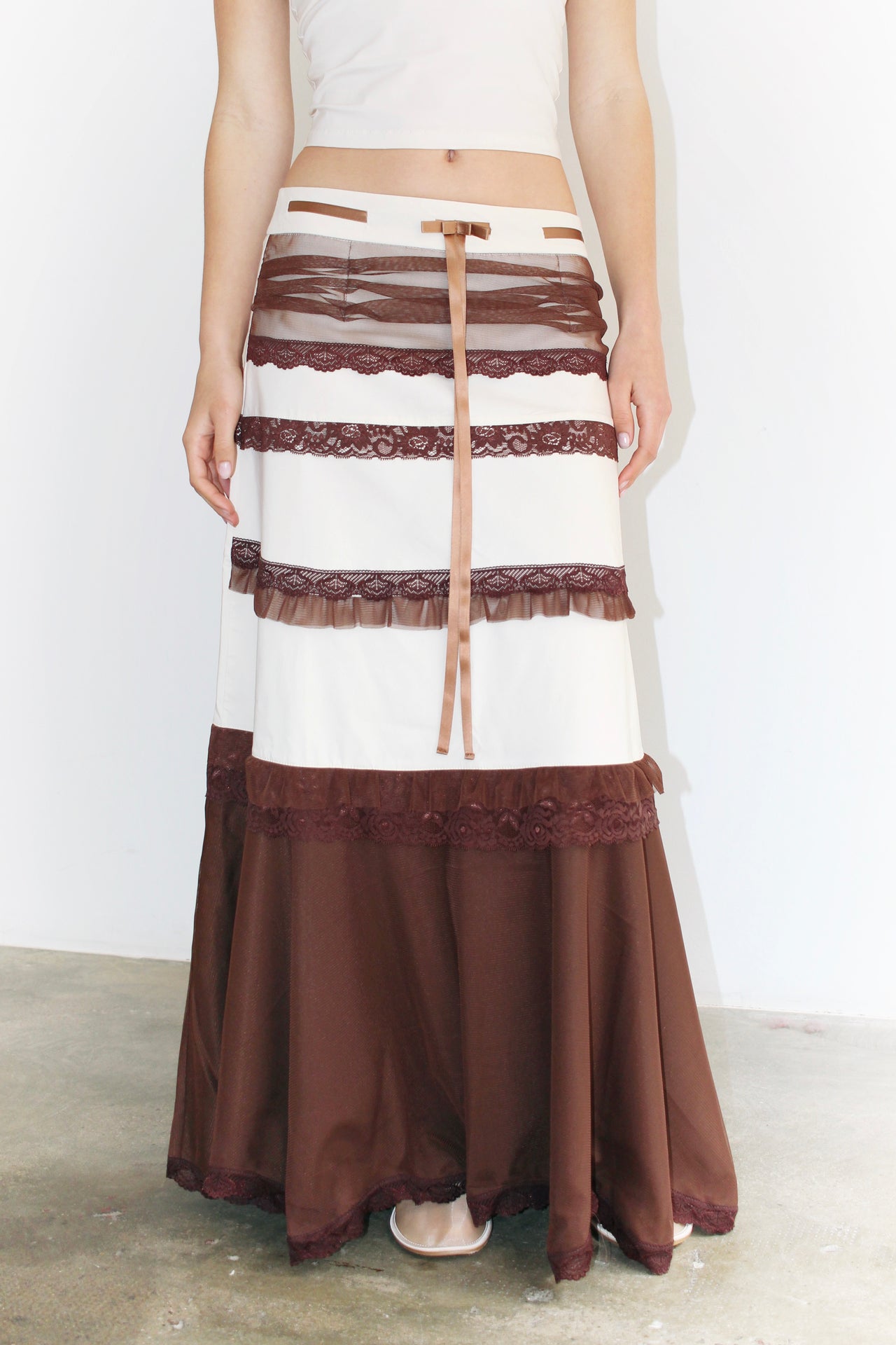 Front view of the Clara Brown Skirt – long skirt with brown and white panels, structured yet flowing silhouette.