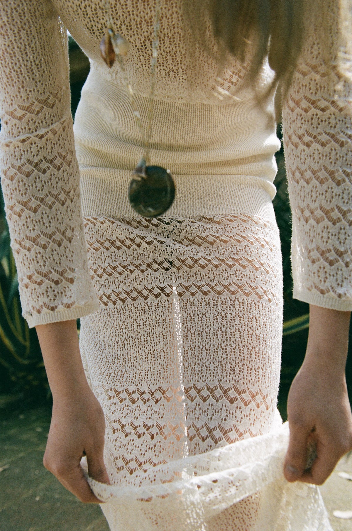 Defne off-white knit top worn outdoors with the matching Yasemin skirt.