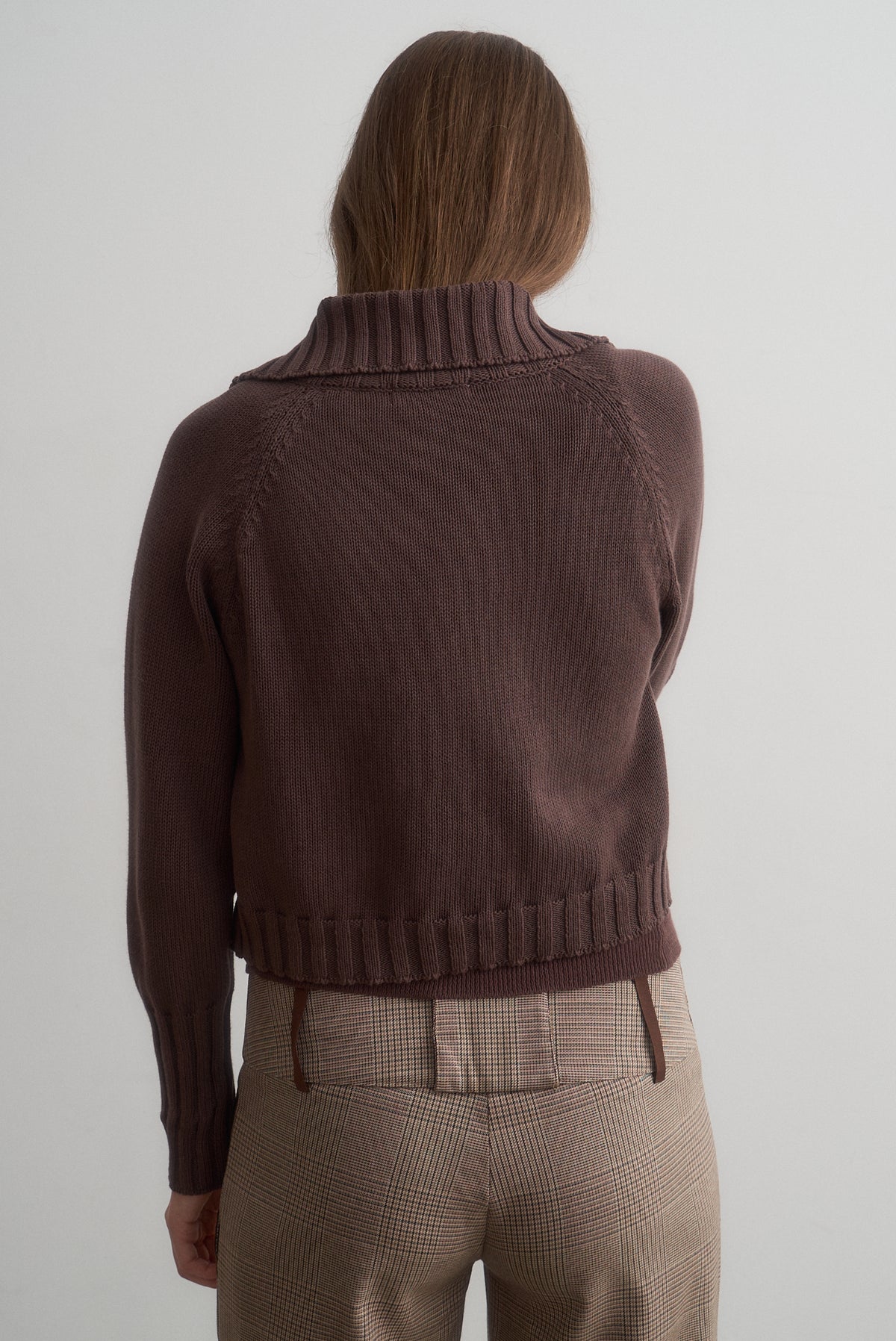 Rear view of Carlita brown knit cardigan styled with Lavinia brown checked trousers.