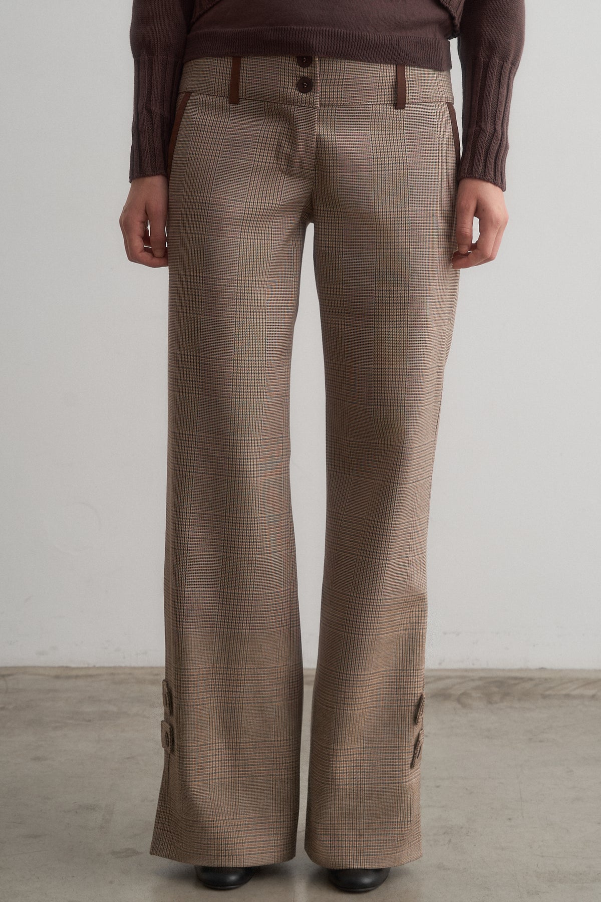 Full-length front view of Carlita brown cardigan and top set worn with Lavinia brown checked trousers.