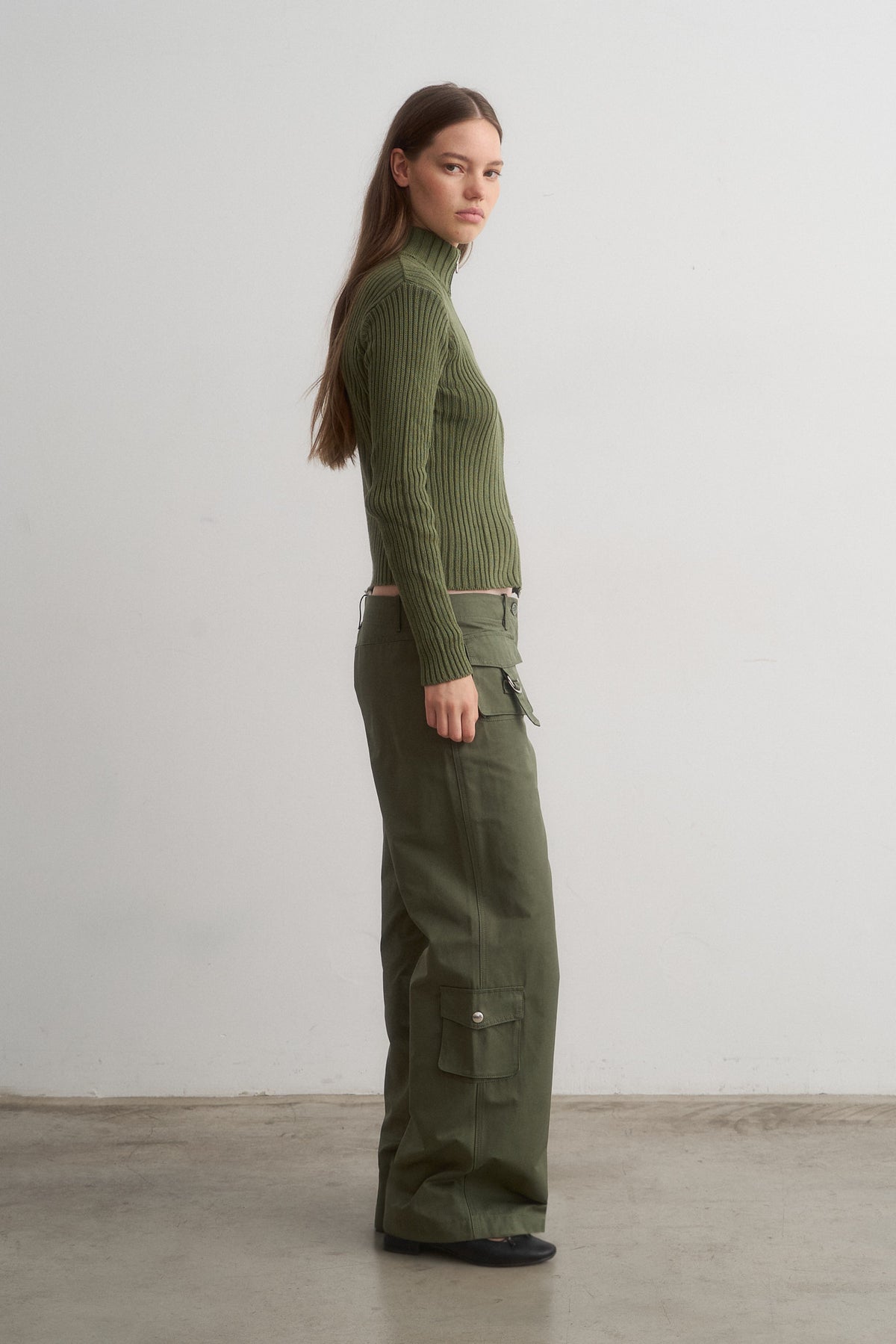 Barca green ribbed knit top worn with green cargo trousers, side view