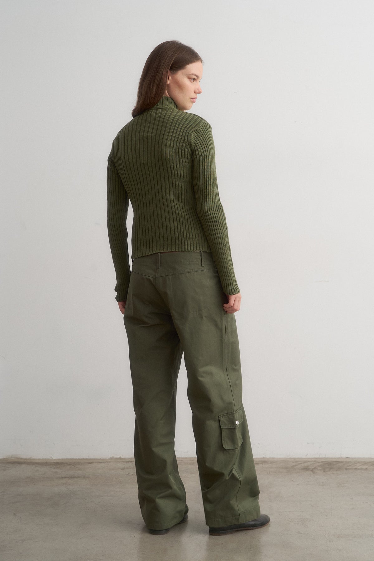 Barca green ribbed knit top worn with green trousers, rear view