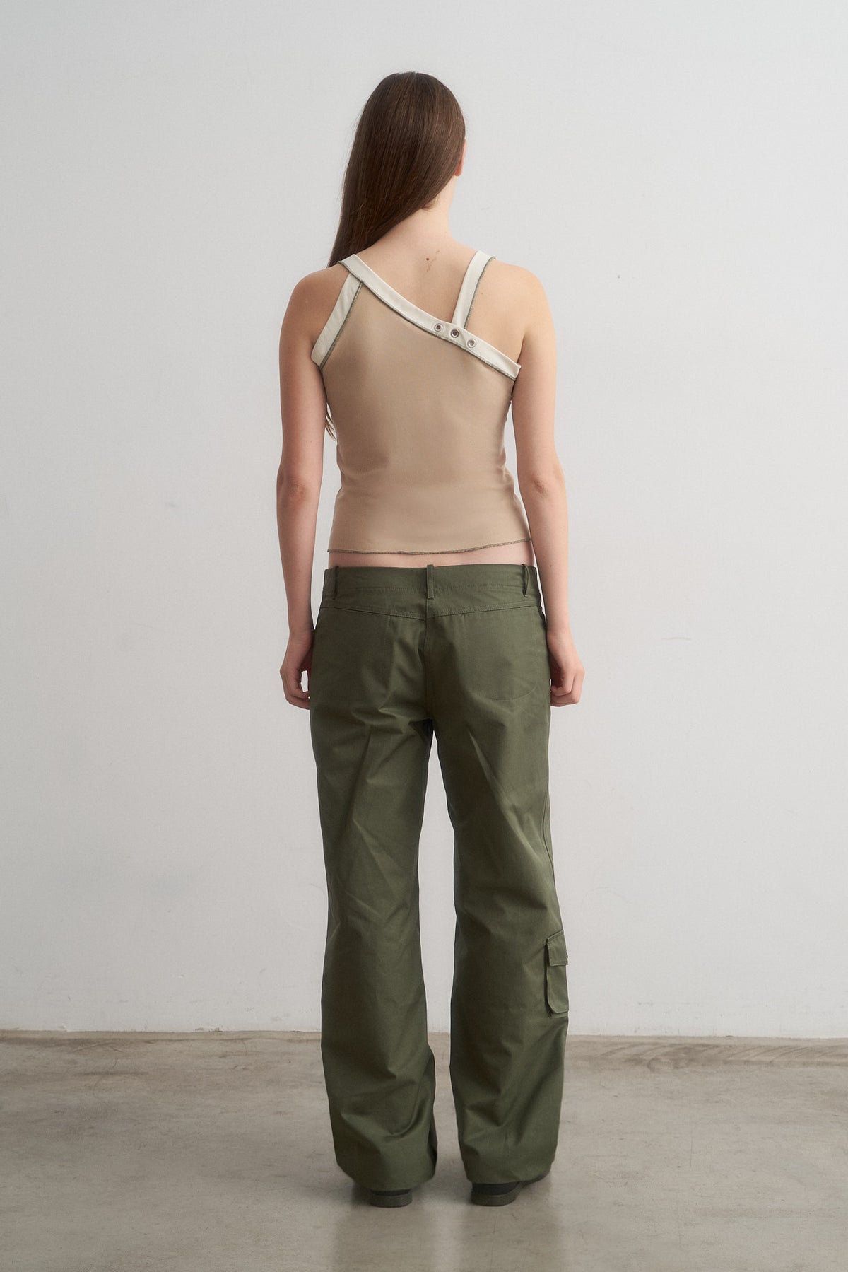 Nat beige top worn with green cargo trousers, rear view