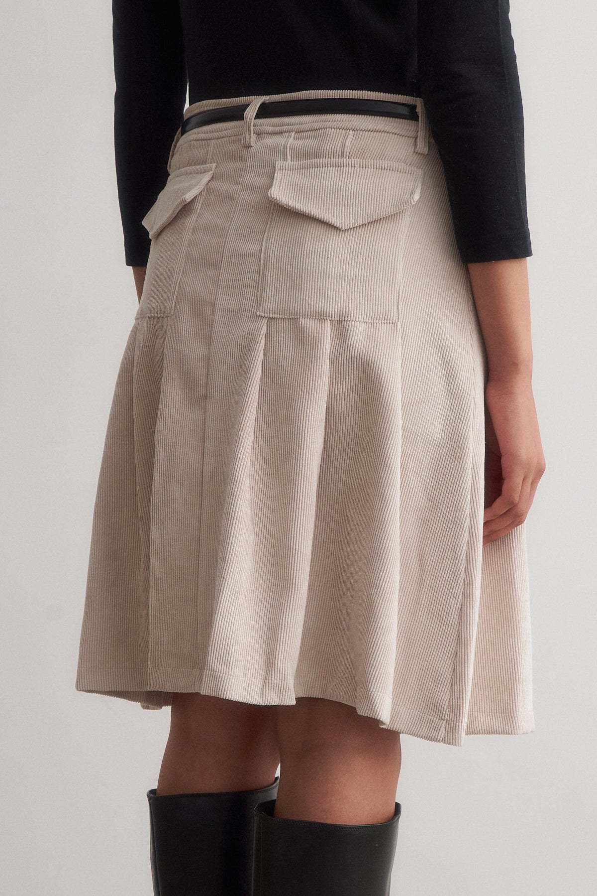 Evie ivory corduroy skirt, rear detail showing the back pockets and pleats