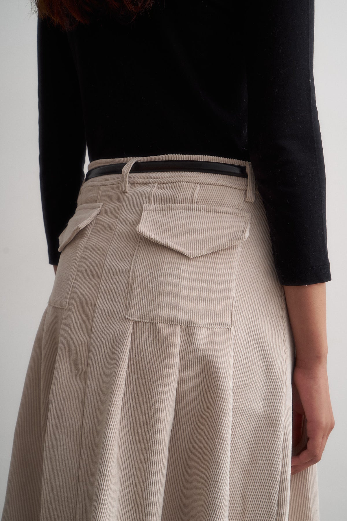 Evie ivory corduroy skirt, close-up of the back pocket and pleats