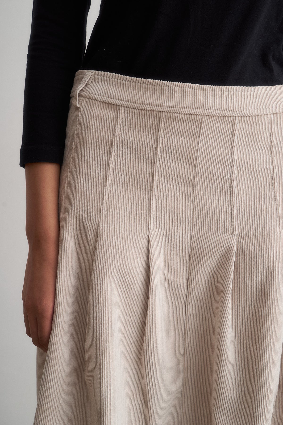 Evie ivory corduroy skirt, close-up of the front waistband and pleats