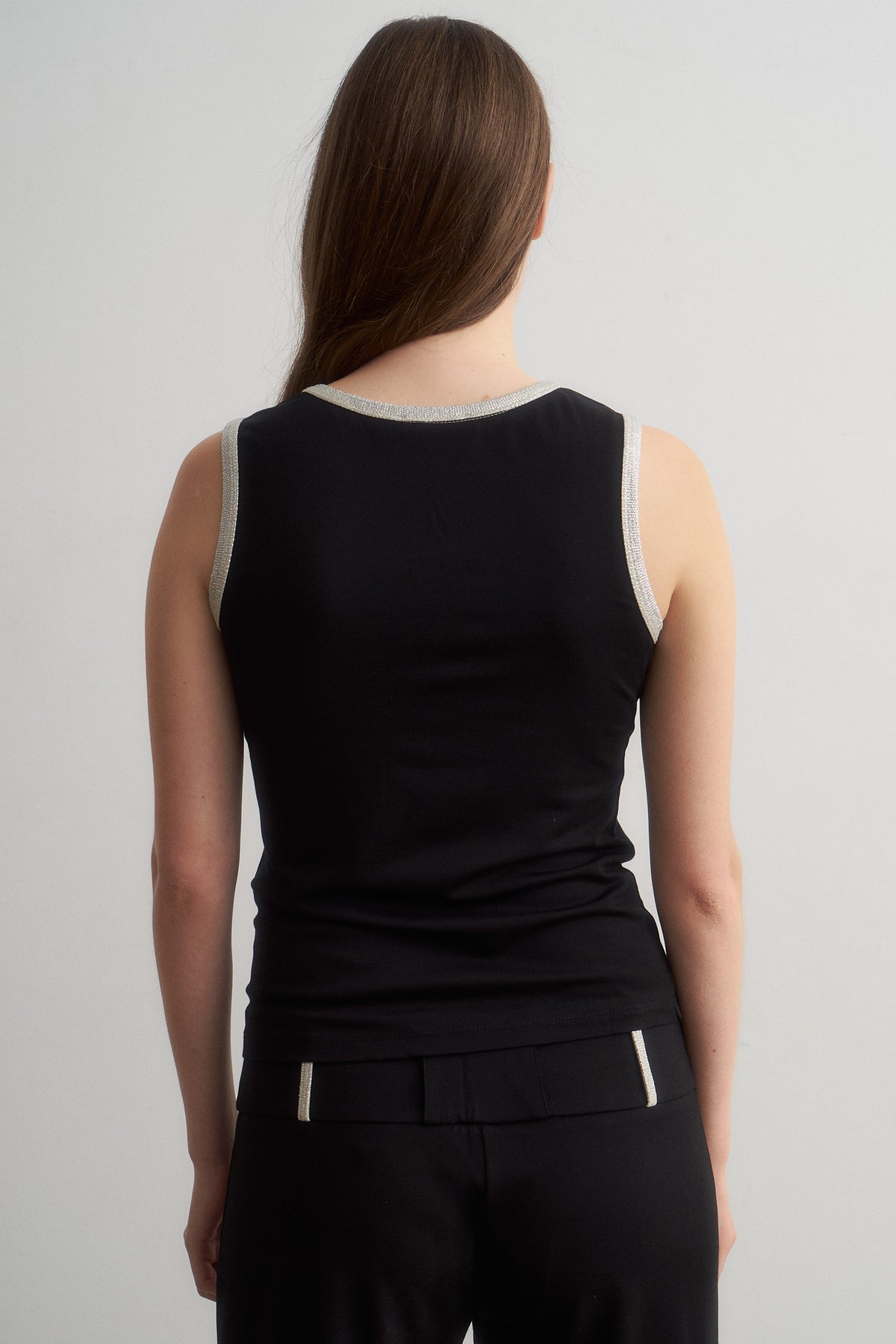 Jade black top, rear detail showing metallic neckline trim