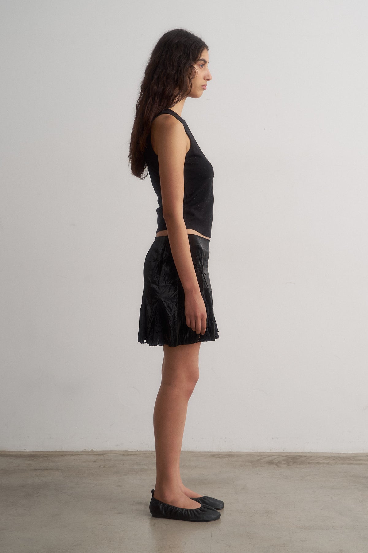 Spritz black sleeveless top and Bellini black mini skirt, side view