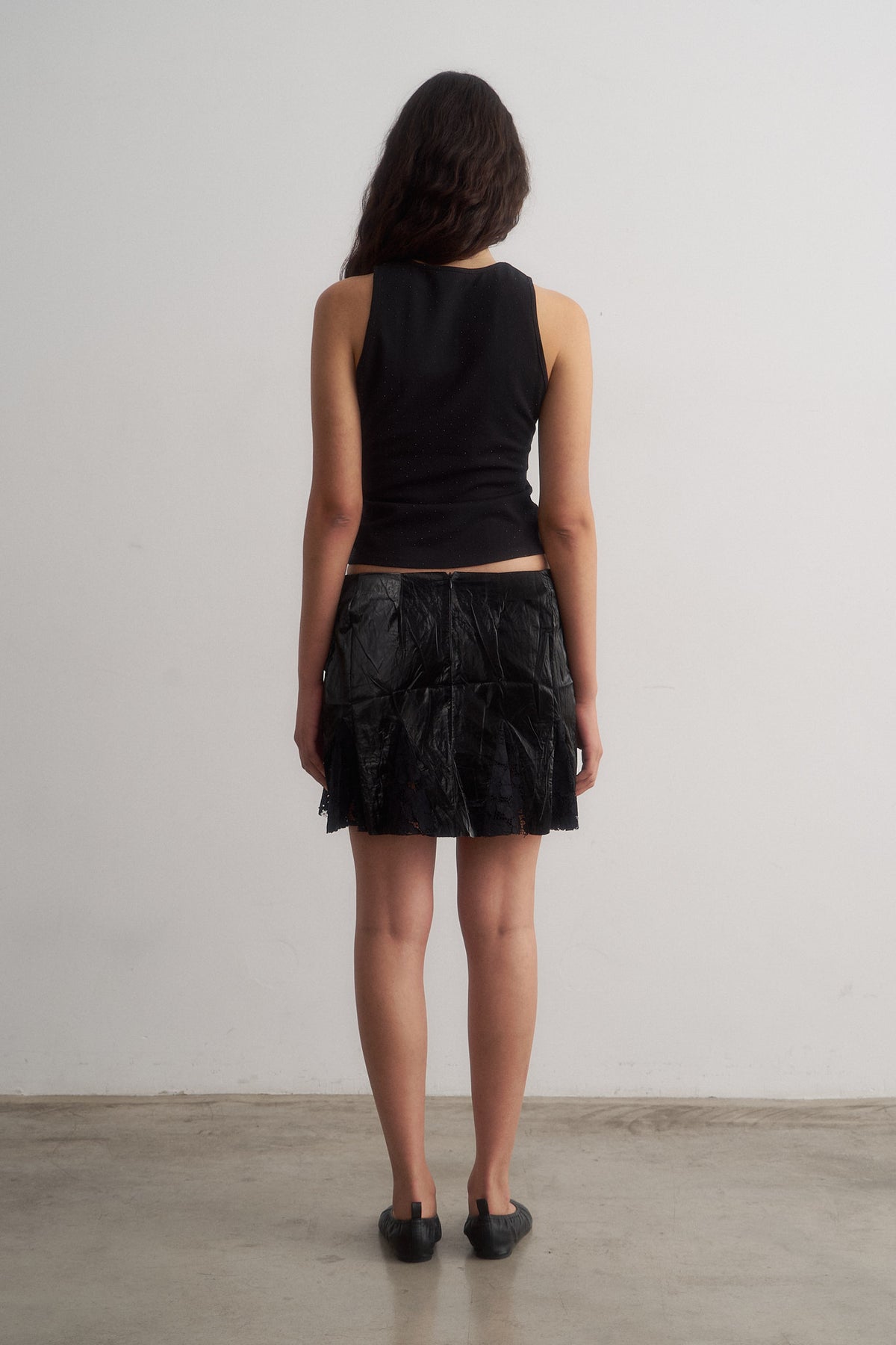 Spritz black top and Bellini black lace-trimmed mini skirt, rear view