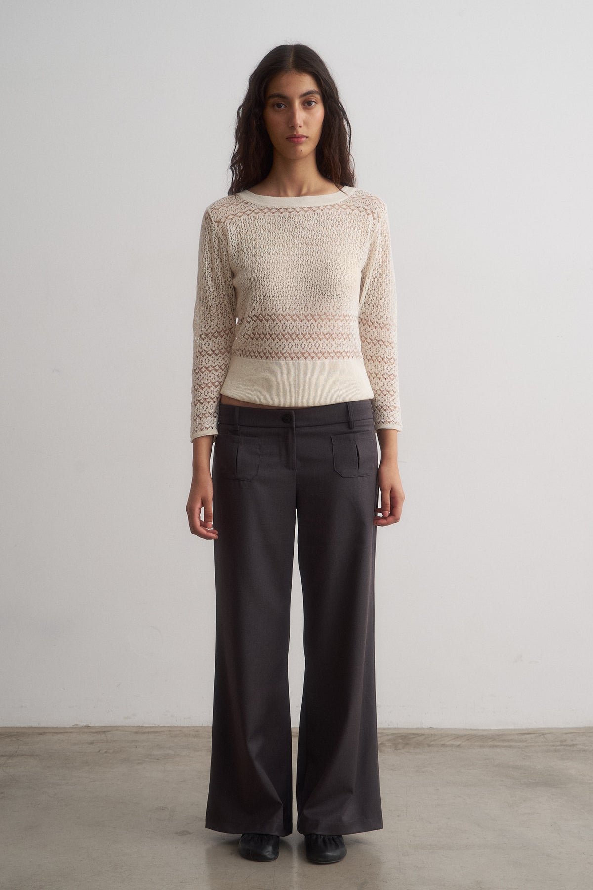 Valentina grey wide-leg trousers worn with a knit top, front view