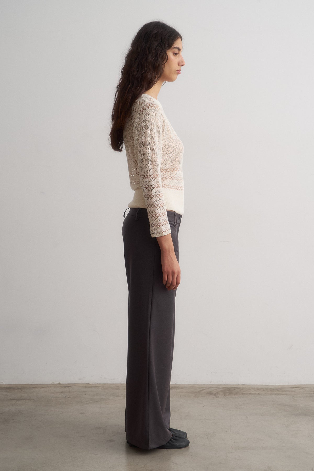 Valentina grey wide-leg trousers worn with a knit top, side view