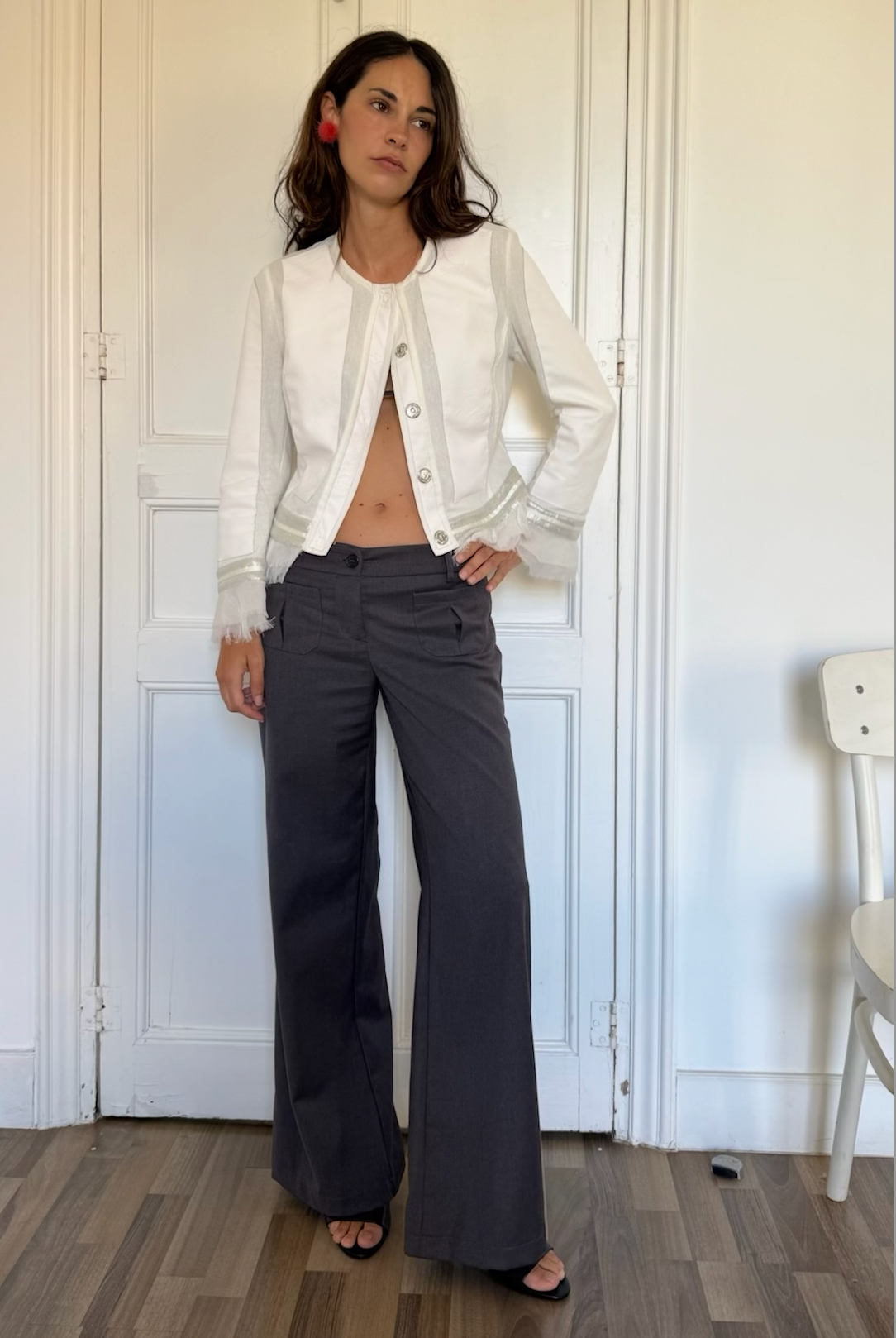Valentina grey wide-leg trousers styled with a white top and jacket indoors